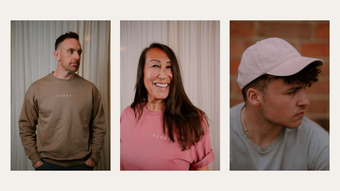 a man wearing a brown sweatshirt that says Gambol on, a woman wearing a pink t-shirt that says Gambol on and a man wearing a pink cap