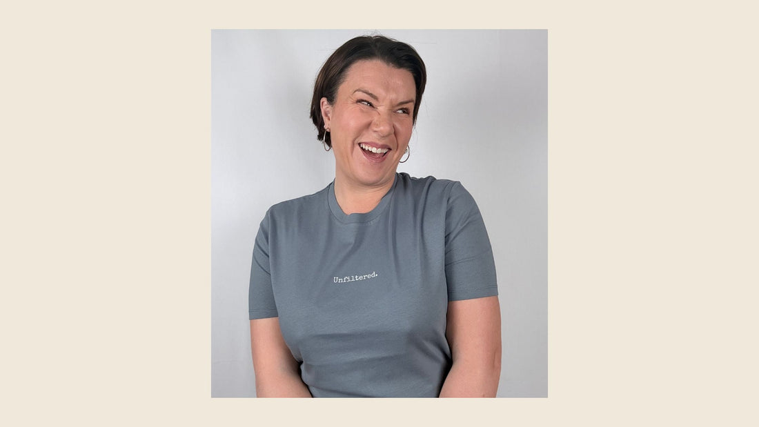 women with brown hair wearing an unfiltered grey t-shirt smiling