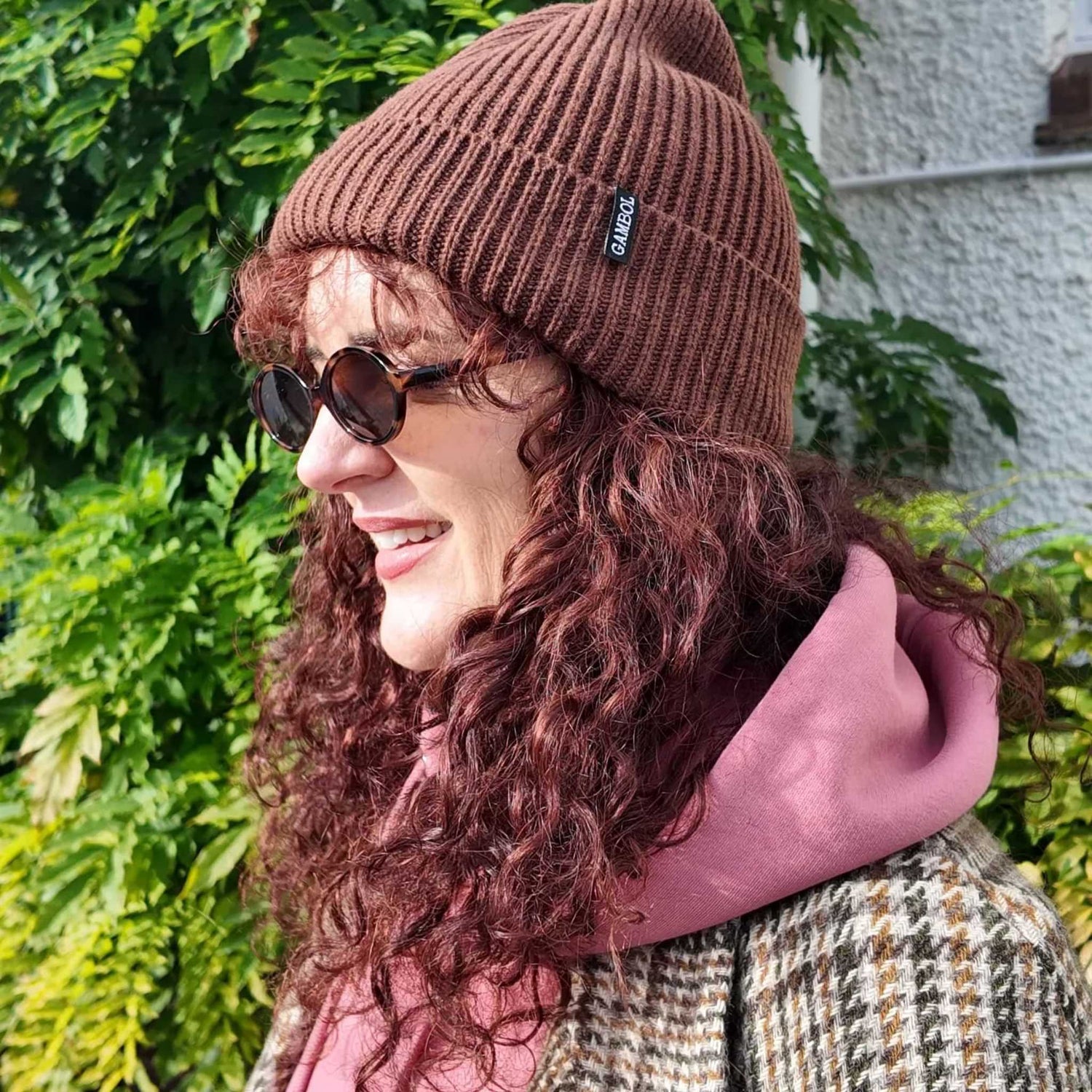 Woman in the sun with a khaki green cap on