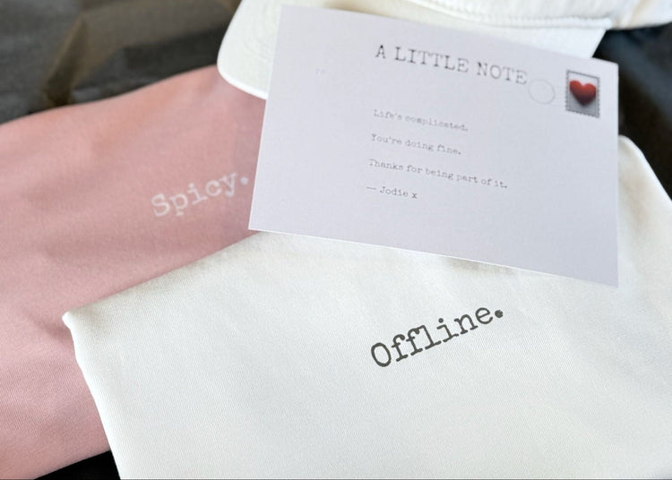a pink t-shirt that says spicy, an ivory one that says offline and a postcard with a header "anlittle note"