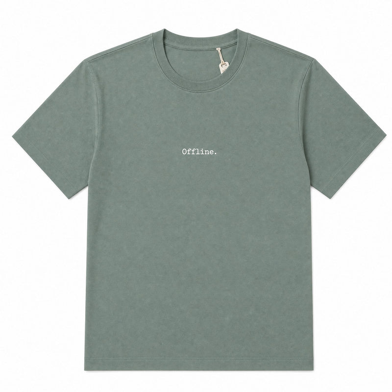 A muted sage green crewneck t-shirt with the word 'Offline.' printed in a small, typewriter-style font on the center chest.