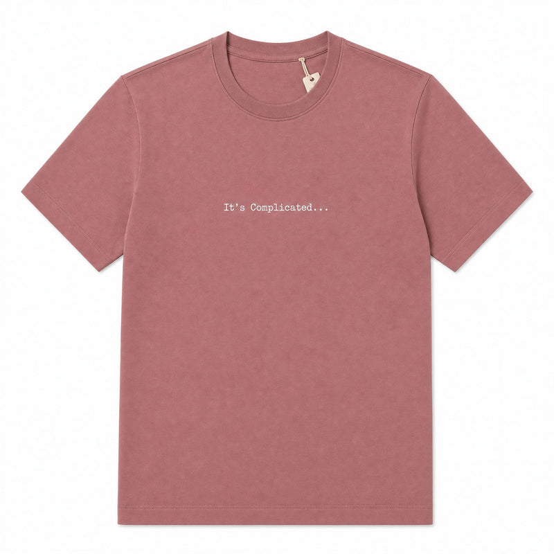 A dusty rose short-sleeve crewneck t-shirt with the text 'It's Complicated.