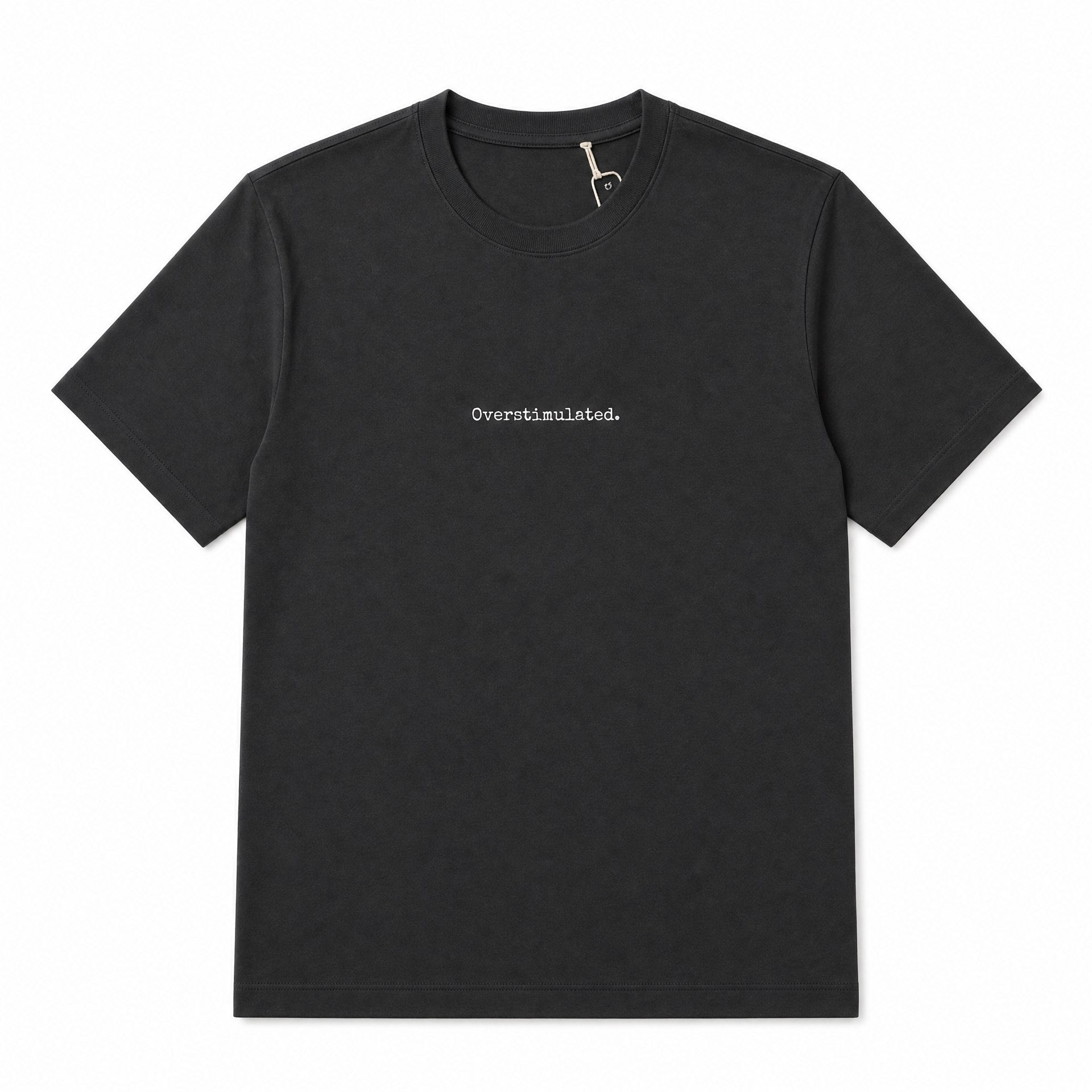 A black short-sleeve crewneck t-shirt with the word 'Overstimulated.' printed in small white serif text on the center chest, displayed flat against a solid white background.