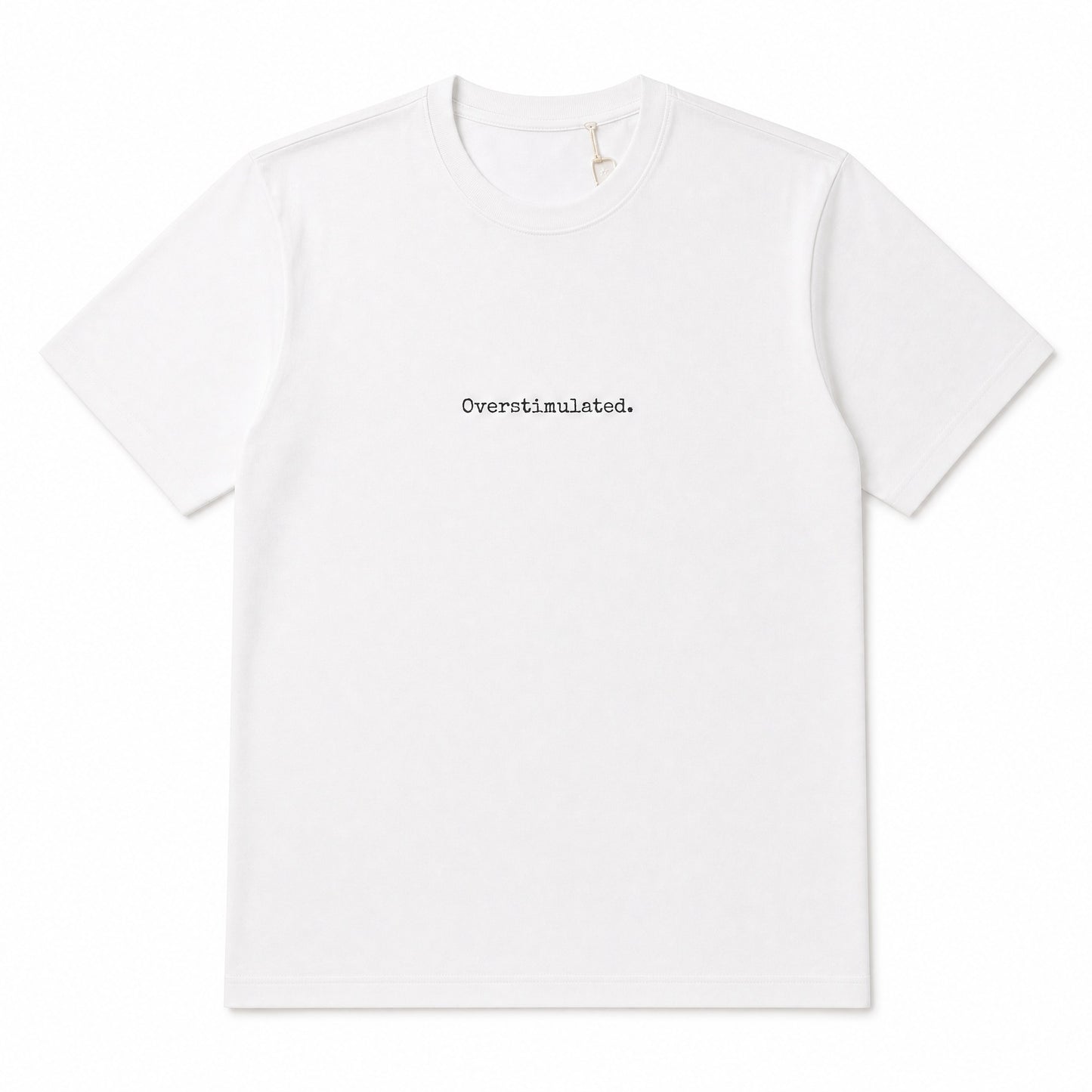 A white short-sleeve crewneck t-shirt with the word 'Overstimulated.' printed in a small black typewriter font at the center chest, displayed on a clean white background.
