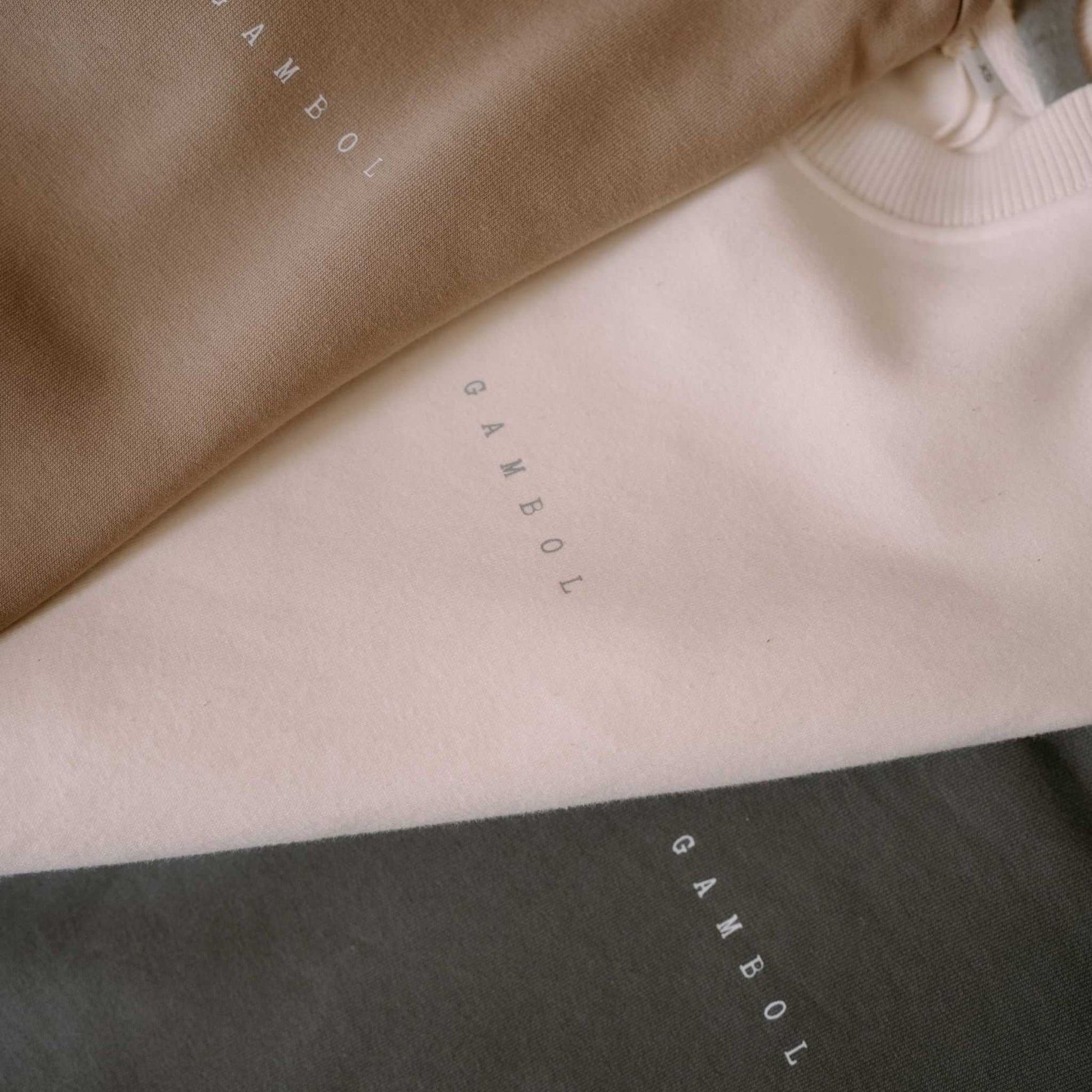 Close-up of fabric with 'Gambol' branding in different colors.