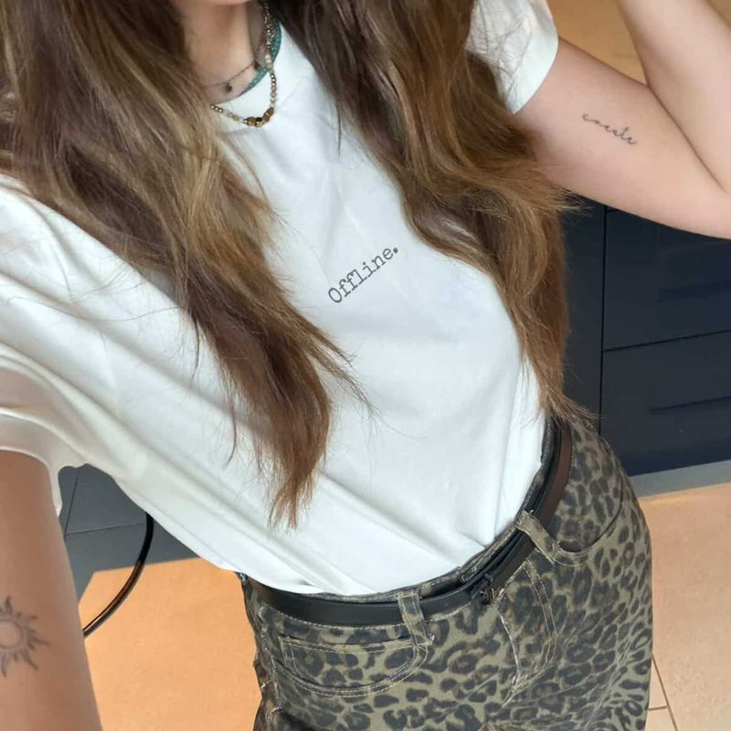 Person wearing a white t-shirt with 'Offline' text and leopard print pants.