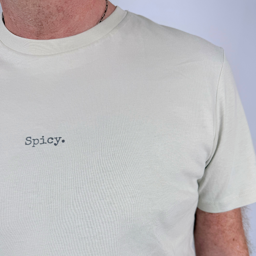 Beige t-shirt with 'Spicy' text on a plain background