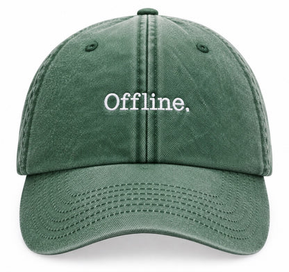 A dark green vintage washed cotton baseball cap with 'Offline.' embroidered in white on the front, shown against a plain white background.