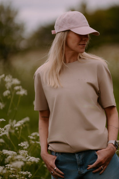 The Relaxed Cap in Petal, worn