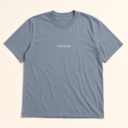 Blue t-shirt with 'Unfiltered.' text on a beige background